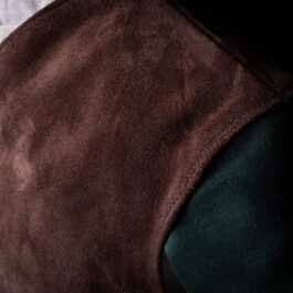 A close up of a person wearing a Suede Elven Jerkin.