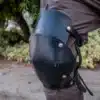 A close up of a person wearing Leather Knee Armor.