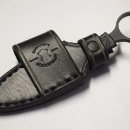 a Handmade Leather Sheath for the Benchmade Mini SOCP Dagger with a black handle.