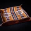 A Handmade Leather Valet Tray with a colorful pattern on it.