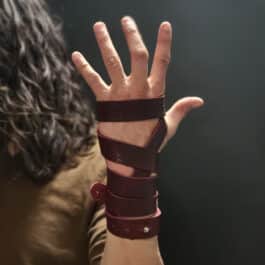 a person with Artisans Bindings on their wrist and hand.