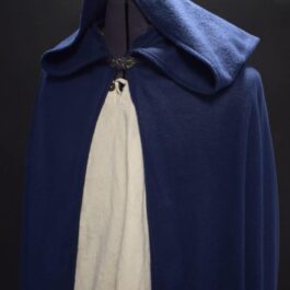 a Fleece Hooded Cloak with a white shirt underneath it.