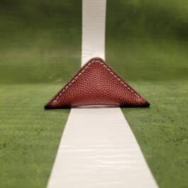 A white line with a red triangle on top of it is not specific enough to be replaced by the product name NFL Leather Finger Football.