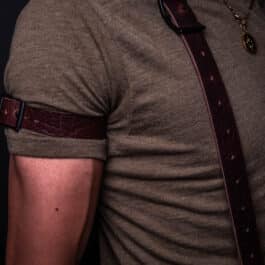 A man wearing a brown shirt and Bison Leather Sleeve Garters.