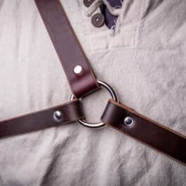 A man wearing Bison Leather Sleeve Garters with a ring on them.