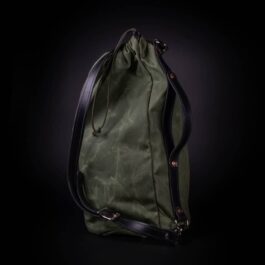 A green Waxed Canvas Duffel Bag on a black background.