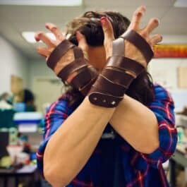 a woman with her hands wrapped around her face.