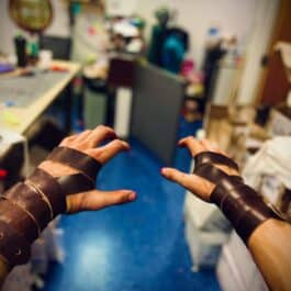 a person with a pair of leather wrist wraps.