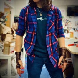 a woman in a blue and red checkered jacket.