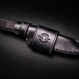 a Waxed Canvas Duffel Bag on a black surface.