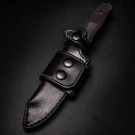 a Waxed Canvas Duffel Bag on a black surface.