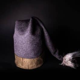 a Fleece Hooded Cloak with a feather on top of it.