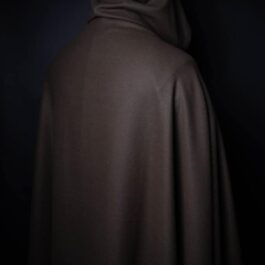 A person in a Fleece Hooded Cloak in the dark.