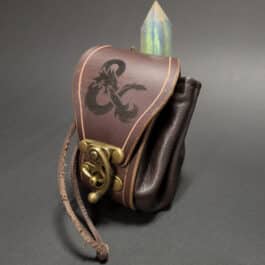 A handmade leather dice bag with a dragon on it.