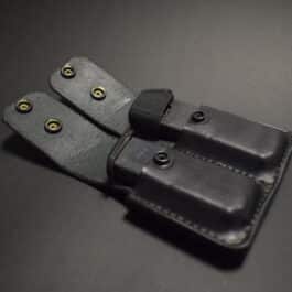 a Ruger Lc9 Double Magpouch on a black surface.
