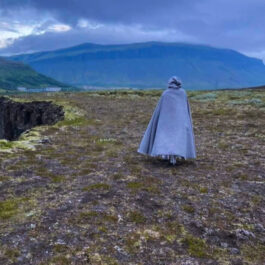a man wearing a wool tweed hooded cloak walking in the mountain - renaissance clothing - renaissance clothing men - renaissance clothing women - renaissance clothing near me - renaissance art clothing - renaissance era clothing - renaissance costume ideas