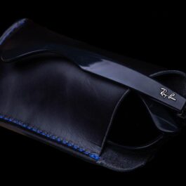 a black leather Eyeglasses Slip with a blue stitch.