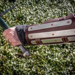 a close up of a person wearing Splinted Vambraces.