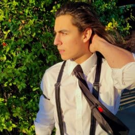 A man wearing Upgraded Leather Sleeve Garters and a tie.