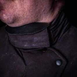 A close up of a man wearing a Simple Gorget.