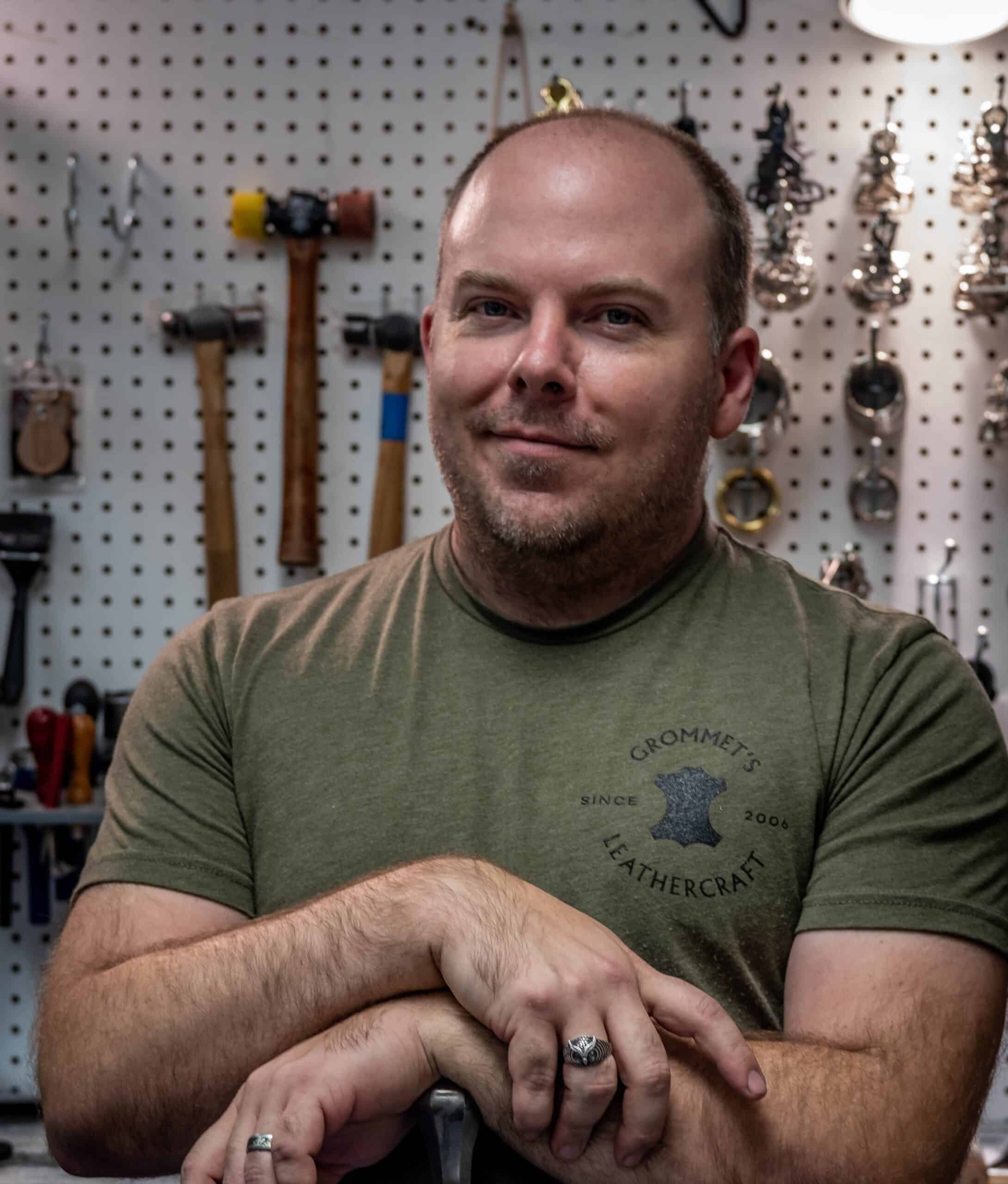 a man sitting at a table with a knife in his hand.