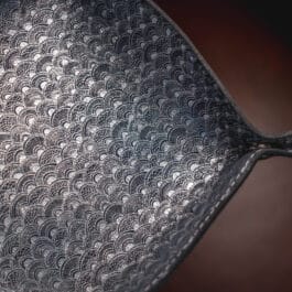 A close up of a Blue Mythical Koi Suede Lined Valet Tray on a table.