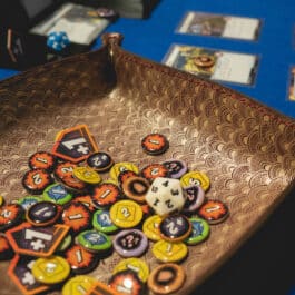 A Burgundy Mythical Koi Suede Lined Valet Tray with a bunch of buttons on it.