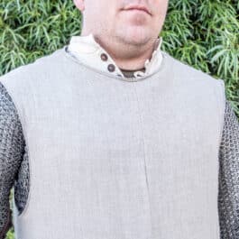 a man wearing a Linen Knights Surcoat - renaissance clothing - renaissance clothing men - renaissance clothing women - renaissance clothing near me - renaissance art clothing - renaissance era clothing - renaissance costume ideas