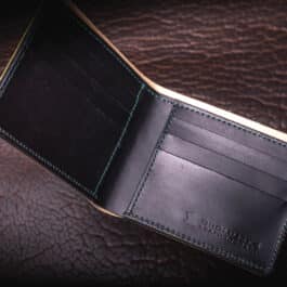 An Emerald Green Shell Cordovan bifold wallet with a card holder.