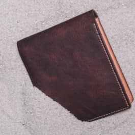 An Old Ben Bifold Wallet laying on the ground.