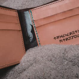 An Old Ben Bifold Wallet with writing on it.