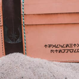 An Old Ben Bifold Wallet with writing on it.