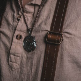 A person wearing leather dress suspenders.