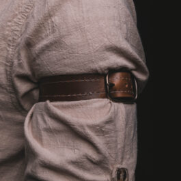 a close up of a person wearing Leather Dress Suspenders.