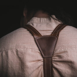 A person wearing Leather Dress Suspenders.