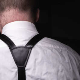 a man wearing a white shirt and Leather Dress Suspenders.