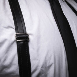 A man wearing a white shirt and black Leather Dress Suspenders.