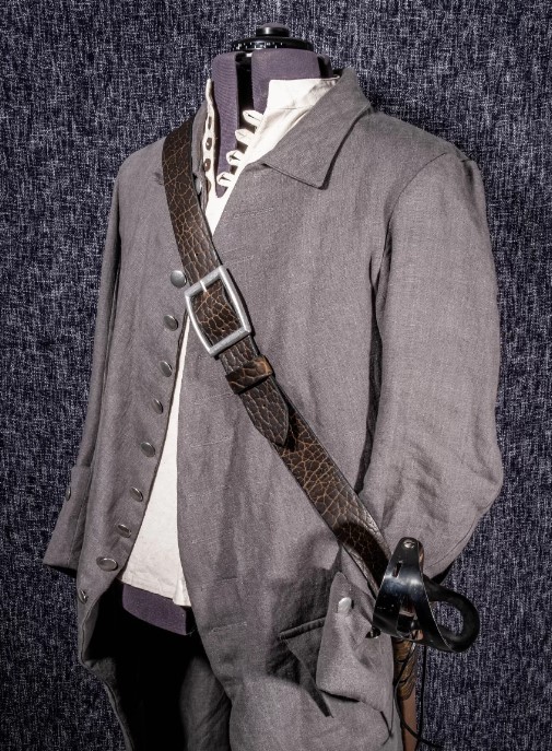 a military uniform with a hat on a mannequin's head.