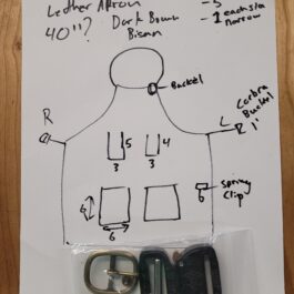 A custom apron with a drawing of a man holding a pair of scissors.