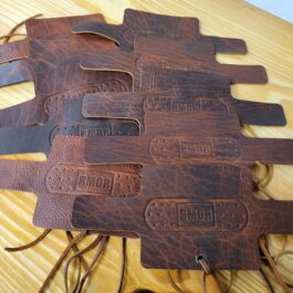 a Knife Burritos for Rmor table topped with lots of brown leather.