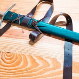 a Wood Core Scabbard for the Albion I:33 laying on a wooden surface.