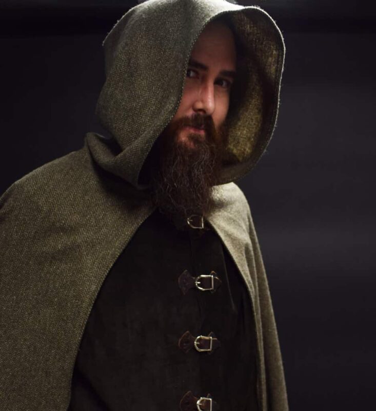 a man with a beard wearing a cape.