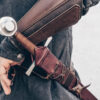 A person holding a Wood Core Scabbard for the Albion Royal Armories I:33 in their hand.