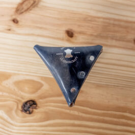 the back view of a blue shell cordovan coin pouch