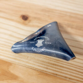 a view of the logo stamped onto a blue shell cordovan coin pouch