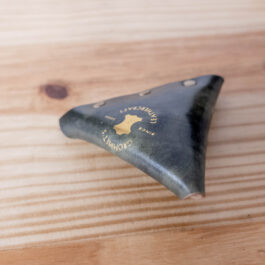 a view of the logo stamped onto a green shell cordovan coin pouch