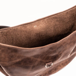 A gray leather bag on a white background