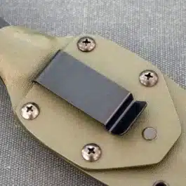 a black steel clip attached to a kydex sheath