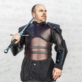 a stunningly handsome man in a suit of leather armor holding a sword.