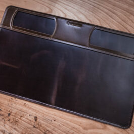 a brown leather mat on a wooden table